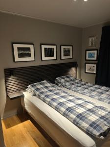two beds in a bedroom with pictures on the wall at Spacious Hemsedal villa with mountain views in Hemsedal