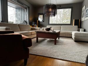 a living room with couches and a coffee table at Spacious Hemsedal villa with mountain views in Hemsedal