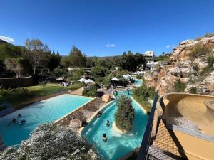 a water park with two pools with people in them at Cottage on Long in Montagu