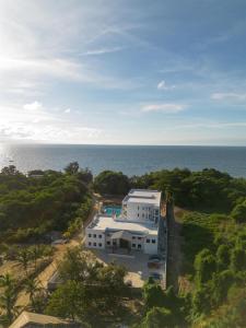 an aerial view of a house with the ocean in the background at Acqua di Mare Resort in West Bay