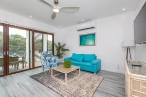 a living room with a blue couch and a table at Acqua di Mare Resort in West Bay