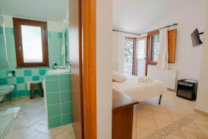 a bathroom with a bed and a sink at Giardini Malaspina in Bosa +119 photos