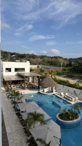 a resort with a swimming pool with umbrellas at Acqua di Mare Resort in West Bay