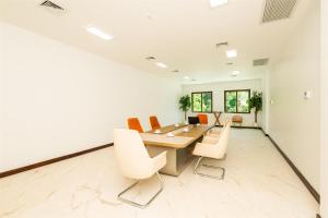 a meeting room with a long table and chairs at Acqua di Mare Resort in West Bay +144 photos