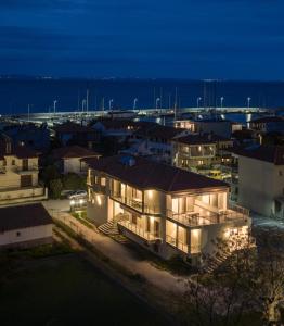 a house with lights on in a city at night at KLG Studios and Apartment in Nikiti