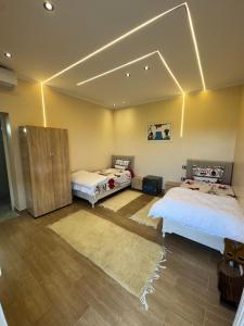 two beds in a room with lights on the ceiling at Dar Hedia in Nabeul +28 photos
