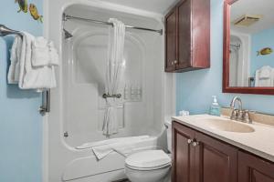 a bathroom with a shower with a toilet and a sink at The Patricia Grand in Myrtle Beach +39 photos