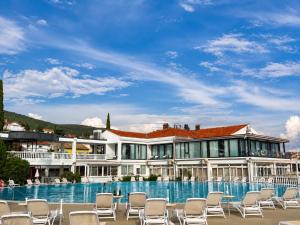 a resort with chairs and a swimming pool at Hotel Millenium deluxe in Selce