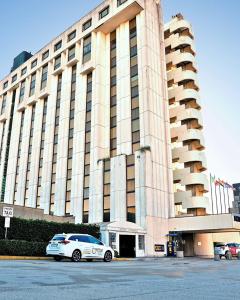 a large building with cars parked in front of it at Four Points by Sheraton Padova in Padova