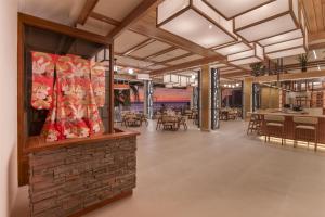 a rendering of a restaurant with tables and chairs at Clarita's Beach Bar & Resort, WorldHotels Elite in Jacó