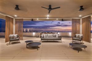 a living room with a couch and two chairs at Clarita's Beach Bar & Resort, WorldHotels Elite in Jacó