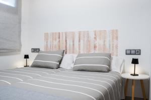 a white bed with two pillows in a bedroom at Apartamentos llerda in Cretas +52 photos