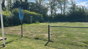 a fence with a blue net in a yard at Beach Resort Kamperland - 1123 in Kamperland +2 photos