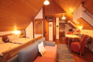 a room with a bed and a couch and a table at Altes Gehöft am Lormanberg in Kirchberg an der Raab