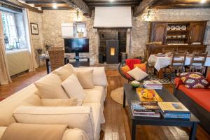 a living room with a couch and a table at LA CORMELLERIE in Saint-Ay