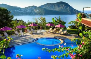 a pool with a view of a lake and mountains at Kalkan Regency in Kalkan