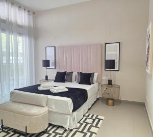 a white bedroom with a large bed and a chair at MD Valterna Suites & Pool in Paterna +136 photos