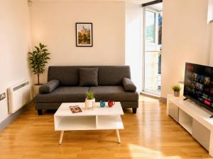 a living room with a couch and a coffee table at York City Centre 1-bed Apartment Near Q-Park Parking - Best Location in York