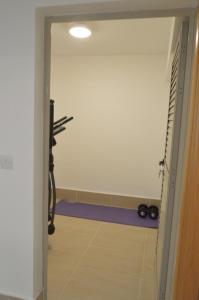 a view of a room with a treadmill and a gym at Leda Beach Villa in Polis Chrysochous