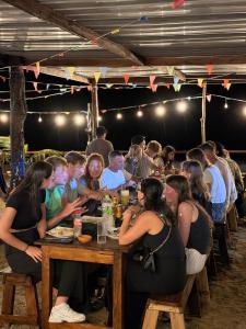 a group of people sitting at a table eating at Garden Beach Hotel in Arugam Bay