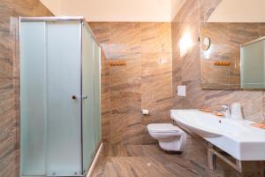 a bathroom with a sink and a toilet and a shower at Hotel Tirreno in Lavagna +24 photos