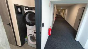 a hallway with a washing machine and a washer and dryer at Pavelkova House in Olomouc