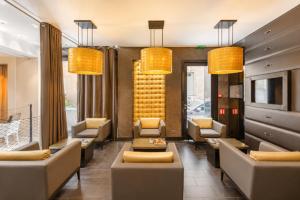 a lobby with couches and chairs in a building at L'Adresse in Paris +29 photos