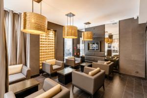 a living room with couches and chairs and lights at L'Adresse in Paris