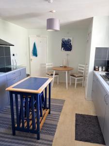 a kitchen with a table and a dining room at Accommodation by the sea on Sanday in Orkney