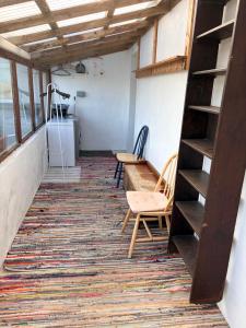 an empty room with two chairs and a table at Accommodation by the sea on Sanday in Orkney +16 photos