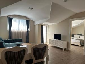 a living room with a couch and a bed and a mirror at Defne Beach Karya in Fethiye