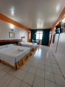 a hotel room with two beds and a television at GoldMen Business Manaus - Taj Mahal in Manaus +54 photos