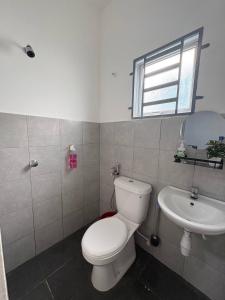 a bathroom with a toilet and a sink at Arowana Homestay MALAY ONLY in Sungai Petani
