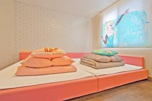 a bedroom with a bed with pillows on it at Daebudo sunshine kids poolvilla in Ansan