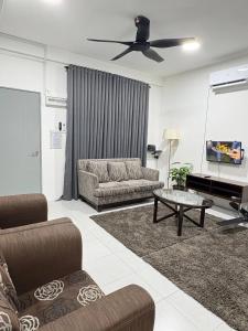 a living room with a couch and a piano at Arowana Homestay MALAY ONLY in Sungai Petani