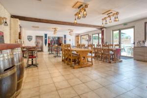 a restaurant with wooden tables and chairs and a dining room at Camping les Pialades - Gite in Nabirat