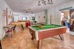 a living room with a pool table and a table at Camping les Pialades - Gite in Nabirat