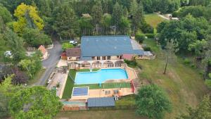 an aerial view of a house with a swimming pool at Camping les Pialades - Gite in Nabirat