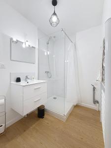 a white bathroom with a shower and a sink at 8C - L'Urban in Saint-Rambert-dʼAlbon