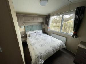 a bedroom with a bed in a small room at Linnet Moselle 5 in Peterhead