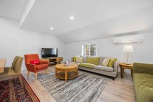 a living room with a couch and a table at Lake Drive apartment in Georgina