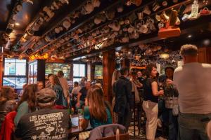 a crowd of people standing in a bar at Nesbitt Arms Boutique Hotel in Ardara +51 photos