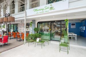 a restaurant with chairs and tables in front of a store at V Style Pattaya North Beach in Pattaya +21 photos