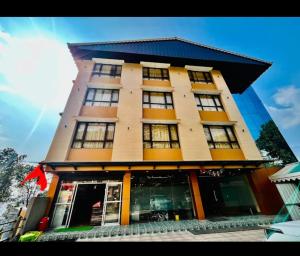 a tall building with windows on the side of it at The Kashyap Castle in Gangtok