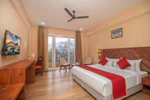 a hotel room with a large bed and a desk at The Kashyap Castle in Gangtok