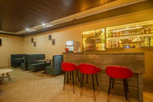 a bar with red bar stools in a restaurant at The Kashyap Castle in Gangtok