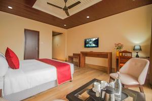a bedroom with a bed and a desk and a table at The Kashyap Castle in Gangtok +5 photos
