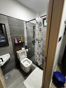 a bathroom with a toilet and a sink at ZIVA HOMEs 2 in Marimbeti