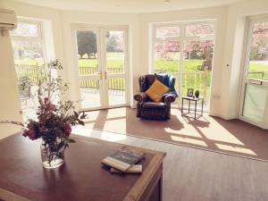 a living room with a chair and a table at Endsleigh Park Hotel in Hull