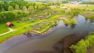 an aerial view of a river with a house and trees at Fisherman’s Dream in McArthur